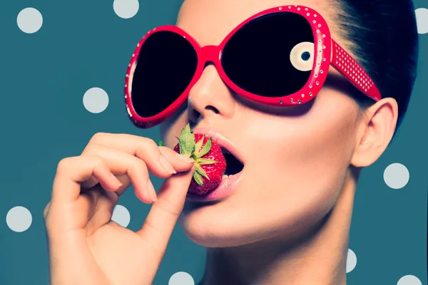 Sexy woman  eating strawberry