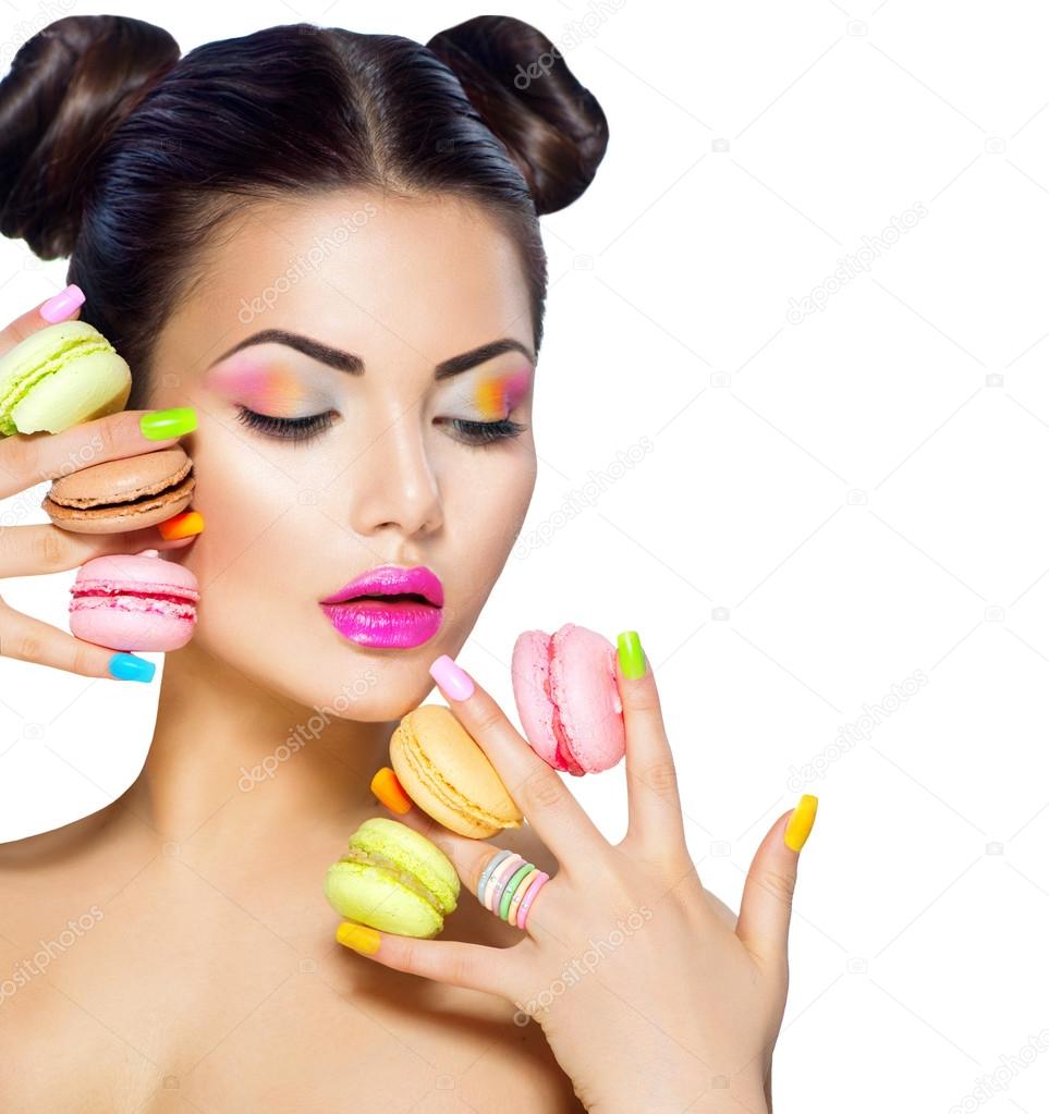 woman holding colorful macaroons