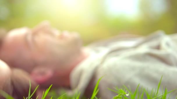 Couple relaxant sur herbe verte . — Video