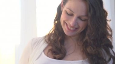 Hamile bir kadın karnını okşuyor.