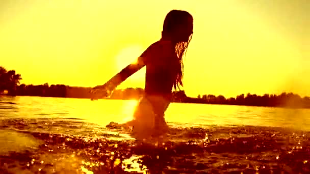 Girl  splashing water in the river — Stock Video