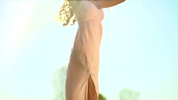 Girl in dress on a spring field. — Stock Video