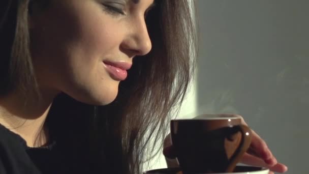 Lady with cup of steaming beverage. — Stock Video