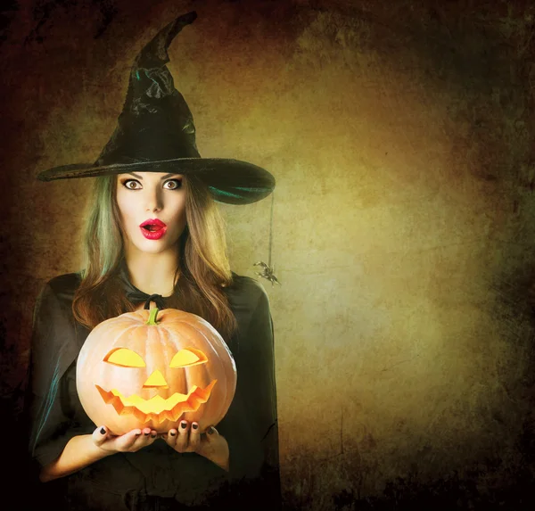 Witch holding carved Jack lantern — Stock Photo, Image