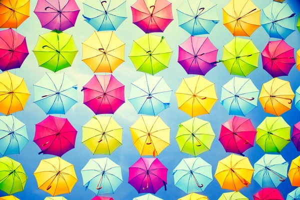 Multicolored umbrellas over blue sky — Stock Photo, Image