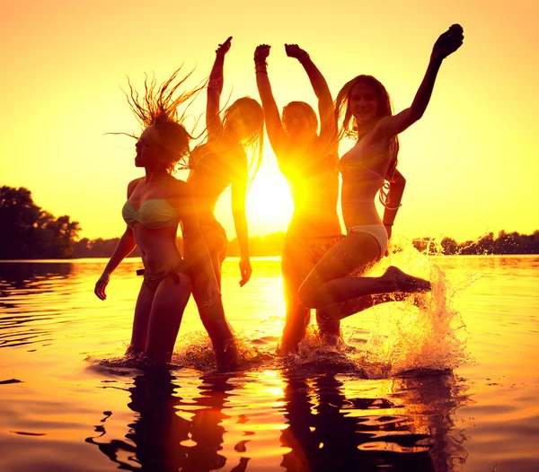 girls dancing in water on beautiful