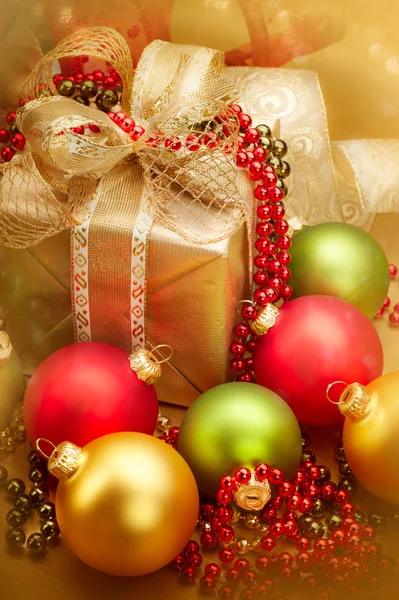 Christmas golden gift box with baubles — Stock Photo, Image