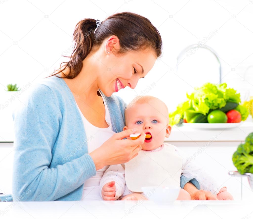 Mother feeding her baby girl