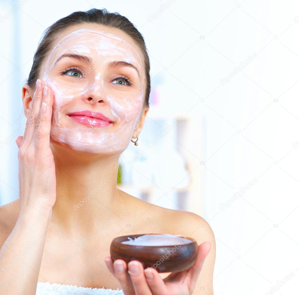 Woman applying facial mask Stock Photo by ©Subbotina 95502108