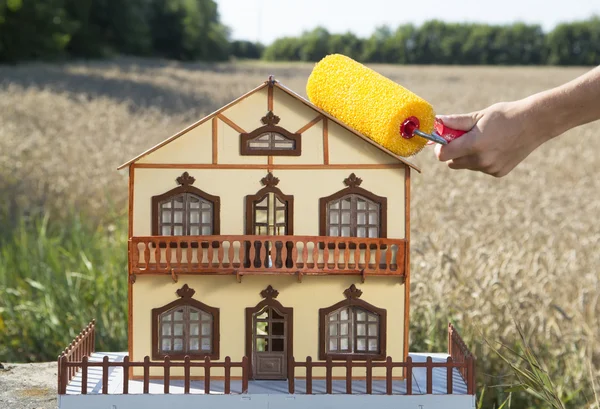 Hand painting roof with roller — Stock Photo, Image