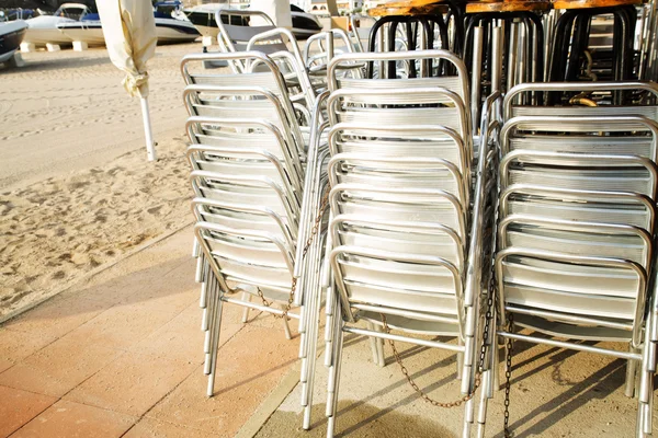 Metal chairs stacked in the restaurant on the beach — Stock Photo, Image