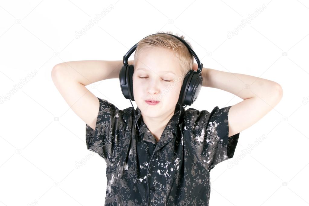 Teenager listening music with headphones, isolated on pure white.