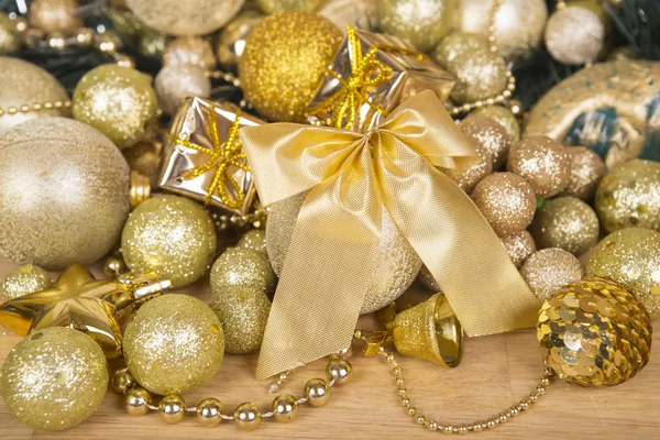 Christmas gold bow on wooden surface Royalty Free Stock Photos