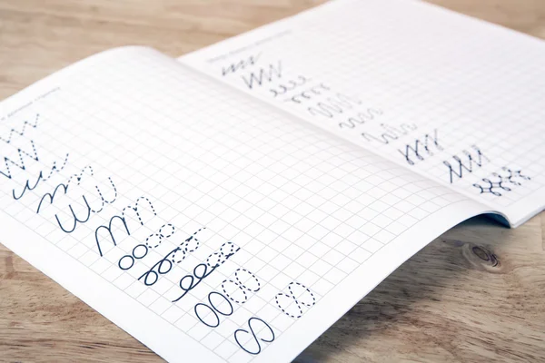 Exercise book on the wooden table — Stock Photo, Image