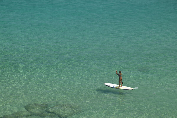 Stand-up paddle in a crystalline sea beach in Fernando de Noronha,Brazil