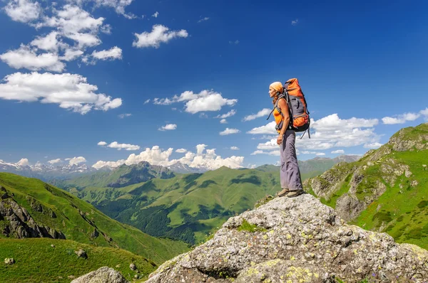 Wandelaar met rugzak ontspannen op de top van een berg Rechtenvrije Stockfoto's