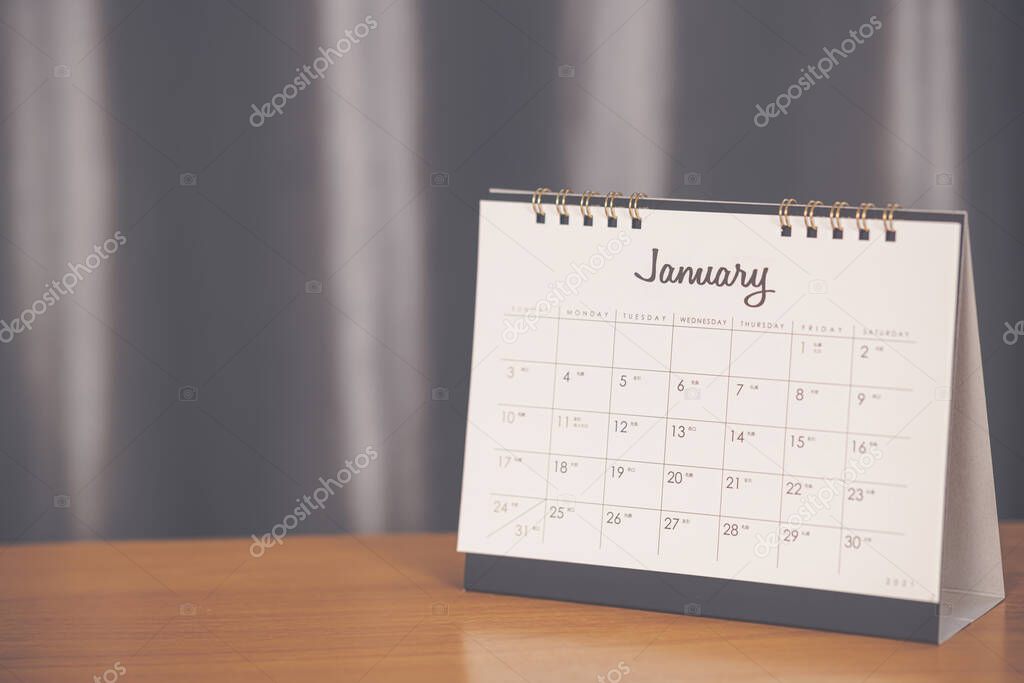 Month January in 2021 paper calendar on the wooden table