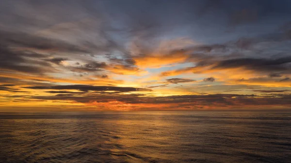 Beautiful cloud sunset in open ocean Colorful views of the surface of the water and the sky with clouds.Natural Sunset Scene Over ocean.
