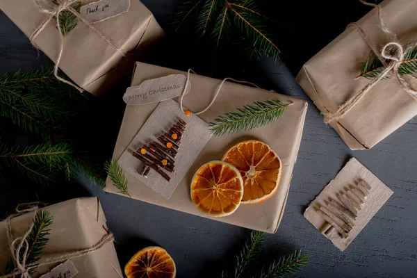 Christmas and zero waste, eco-friendly packaging gifts in kraft paper, dried oranges, Christmas tree branches. eco-Christmas holiday concepts, eco-decor. High quality photo