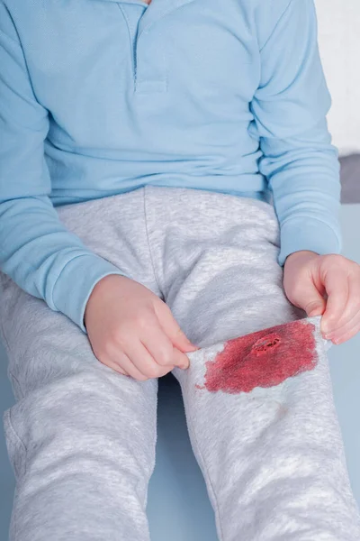 dirty blood stain on clothes. The concept of cleaning stains on clothes. Isolated on a blue background. High quality photo