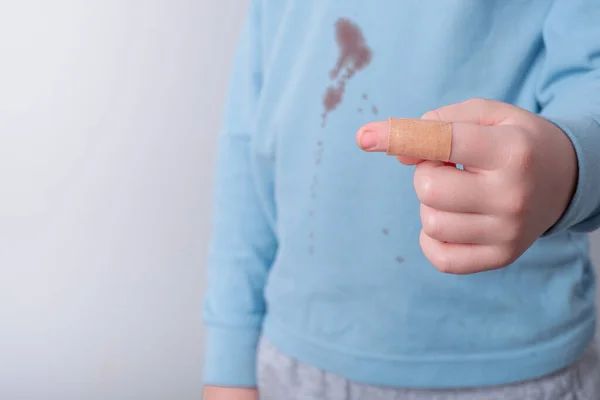 Closeup Kid Finger Sticking Plaster Dirty Blood Stain Shirt Background — Stock Photo, Image