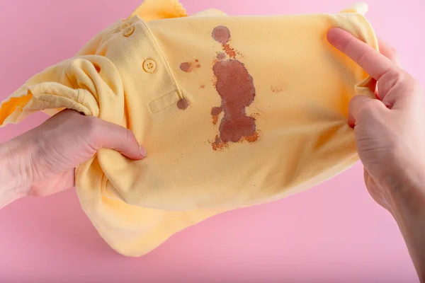 Female Hands Showing Blood Stains Yellow Clothes Isolated Pink Background — Stok fotoğraf