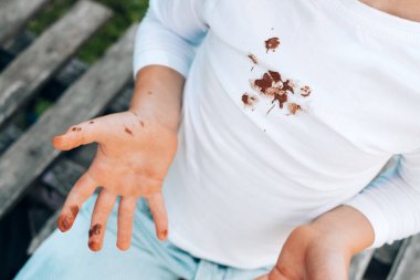 Chocolate stains on children's clothes. daily life dirty stain for wash and clean concept. top view. High quality photo clipart