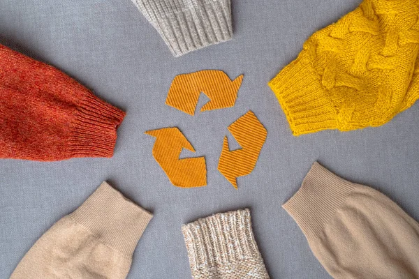Clothing recycling. Used clothes. Ecological and sustainable fashion. sleeves of autumn woolen sweaters. reduce waste concept