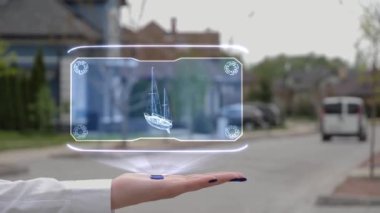 Hologram yelkenli gemi gösteren bir kadın el.