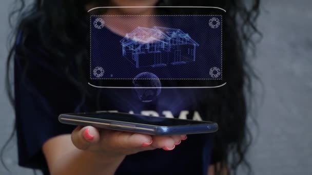 Vrouw toont HUD hologram huis — Stockvideo