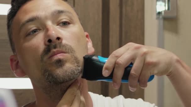 Az ember borotválja az arcát. — Stock videók