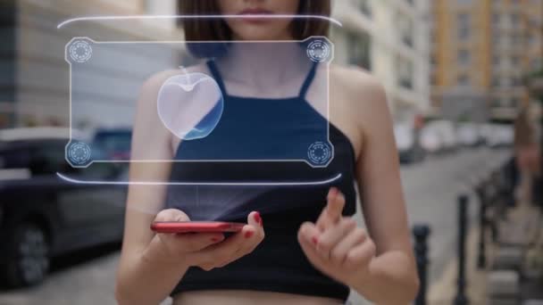 Young adult interacts hologram apple — Stock Video