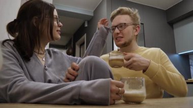 Arkadaşlar içkileri paylaşır. Birlikte gündelik kahve içeceğiz. Rahatlamış kahve buluşması sırasında samimi bir arkadaşlık. Sıcak içeceklerden ve evdeki eğlenceli etkileşimlerden hoşlanan bir çift.