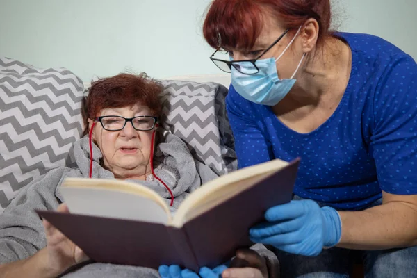 Caregiver with senior woman in nursing home , Nurse helping senior woman