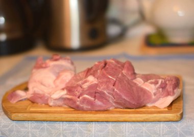 Tahtada domuz eti dilimlenmiş.