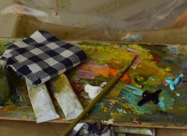 paints and brushes on the artist's palette