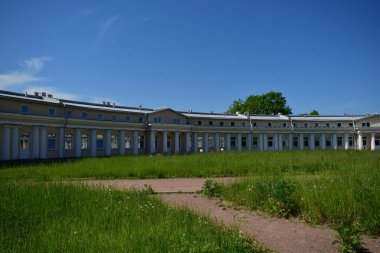 Parktaki bina, bahçe düzenlemesi, insan dinlenme yeri.