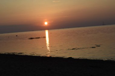 Sahilde gün batımı, deniz