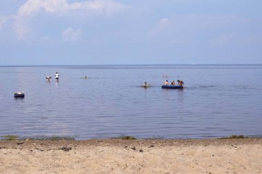 Kumsalda ve kumsalda dinleniyor.