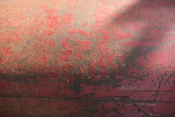 Pattern of old painted metal surface. Rusty metal, peeling paint, red tones, bright colors