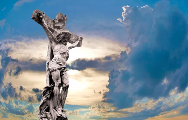 Crucified Jesus Christ against dramatic sunset — Stock Photo, Image