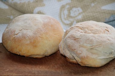 Ahşap bir tahtanın üzerinde el yapımı çıtır ekmeğin yakın plan fotoğrafı.