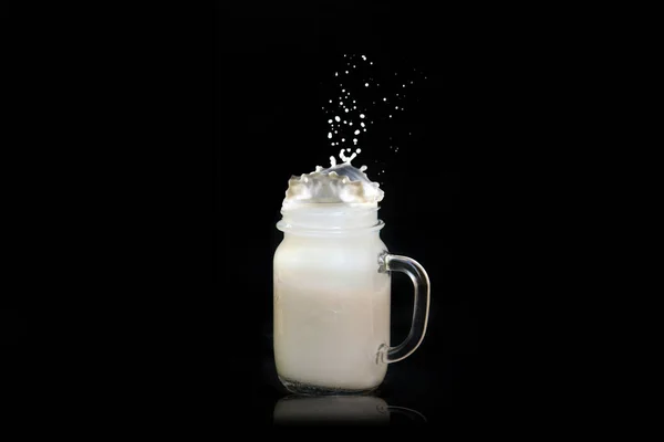 Milk Splashes Out Transparent Square Jar Mug Flies All Directions — Fotografia de Stock