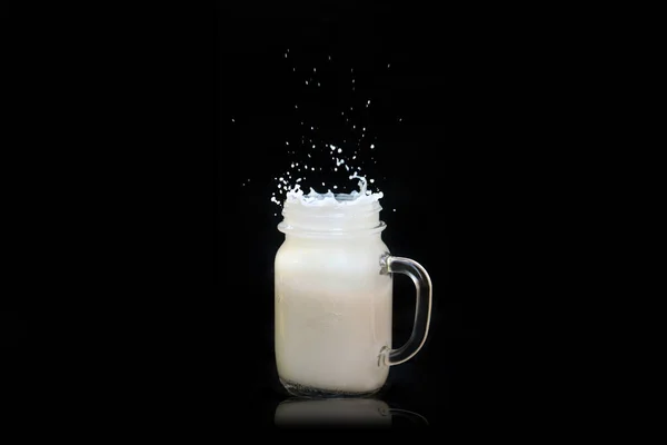 Milk Splashes Out Transparent Square Jar Mug Flies All Directions — Stock Photo, Image