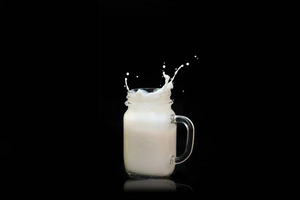 Milk Splashes Out Transparent Square Jar Mug Flies All Directions — Fotografia de Stock