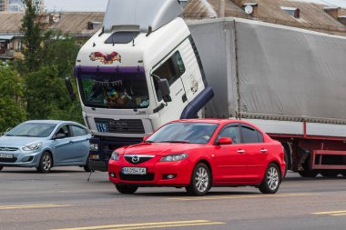 Kyiv, Ukrayna - 30 Haziran 2021: Yoğun bir şehir otoyolunun ortasında bozuk büyük bir kamyon durdu. Arabalar yolun ortasında duran bir kamyonun etrafında dolaşır..