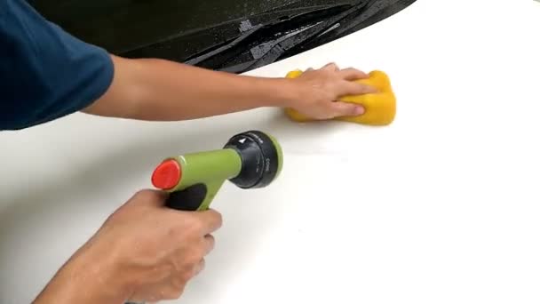 Asian Mans Hand Cleaning Front Bonnet Car With Sponge And Squirt Water Hose — Stock Video