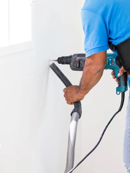 Asian Man Drill On White Wall And Cleaning Dust With Vacuum Together