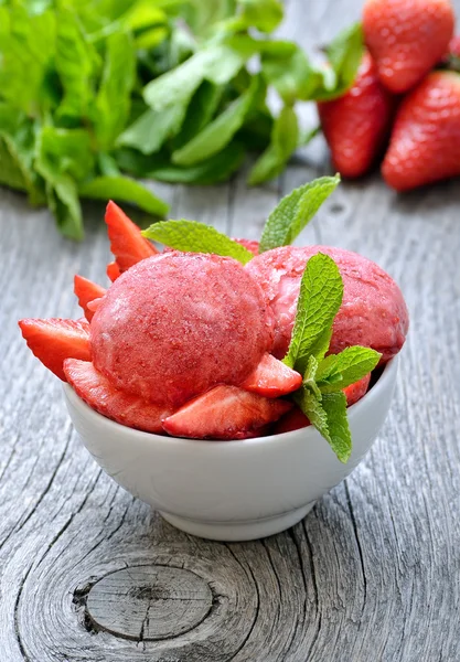 Strawberry sorbet ice cream decorated with mint