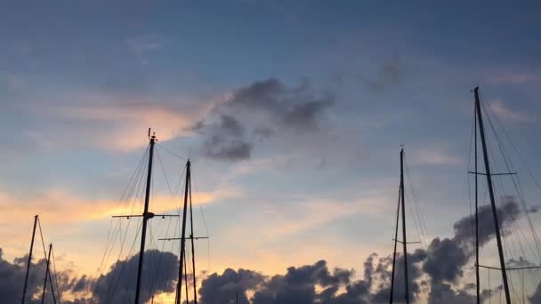 Masts of sailing ships on a background of blue sky with clouds. — Stock Video